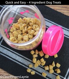 a bowl filled with dog treats sitting on top of a table next to it's lid