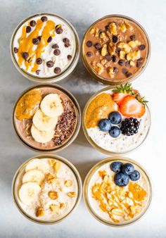 four bowls filled with different types of food on top of a white countertop next to bananas, strawberries, and chocolate chips