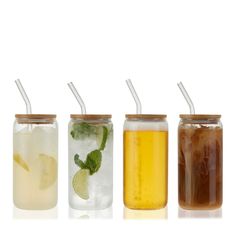 four different types of drinks in jars with straws