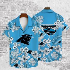 Aop Hawaiian Shirt for Carolina Panthers Fans The Hawaiian Shirt is an iconic symbol of laid-back, tropical style. Crafted from lightweight, breathable fabrics, it offers a comfortable and relaxed fit, perfect for warm weather escapades. Its vibrant, exotic patterns evoke the spirit of the Hawaiian islands, radiating a sense of fun and adventure. With its button-up design and collared finish, it strikes the perfect balance between casual and smart-casual attire. Whether you’re strolling along th