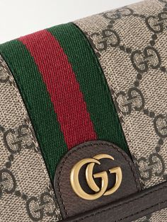 First introduced in 2018, Gucci's 'Ophidia' bag quickly became a fashion staple. This style is crafted from coated-canvas detailed with the label’s signature 'GG' monogram and trimmed with leather and striped webbing. It has an internal zipped pocket for smaller items and an adjustable shoulder strap, should you want to carry it cross-body. Designer Rectangular Wallets With Gold-tone Hardware, Designer Wallets With Gold-tone Hardware, Rectangular Gucci Bag, Gucci Green Bag With Detachable Strap, Green Gucci Bag With Detachable Strap, Gucci Rectangular Shoulder Bag, Designer Gucci Clutch Shoulder Bag, Designer Crossbody Bag With Interior Card Slots, Luxury Gucci Green Shoulder Bag