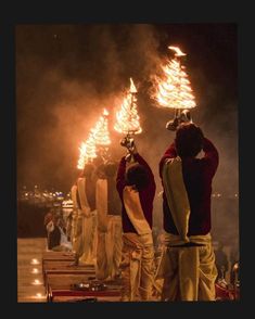 some people are standing around with torches in their hands