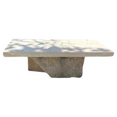 a stone table with a white top on a white background in the shape of a rectangle