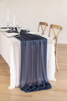 the table is set with white and blue linens