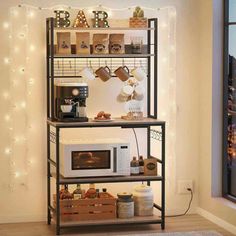 a microwave oven sitting on top of a metal shelf next to a wall with lights