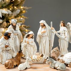 the nativity scene includes figurines of jesus, mary, joseph and baby jesus