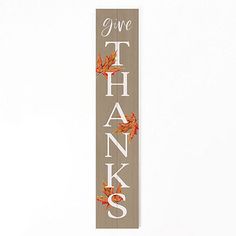 a sign that says give thanks with leaves on it