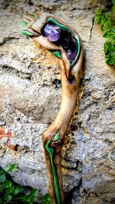 a piece of driftwood that has been placed on the side of a rock wall