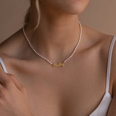 Delicate florals and pearls are a necessity for an elegant afternoon tea and brunch with the girls. Make the occasion feel even more special by taking the classic pearl necklace a step further by adding a personalized touch with our Minimalist Pearl Necklace featuring a custom dainty nameplate charm.• Material: High Quality Solid 925 Sterling Silver• Finish: Sterling Silver ∙ 18K Gold ∙ Rose Gold• Dimensions: Depending on your font choice, height sizes range from 3mm to 4mm lowercase SKU: MM-NM1 Classic Pearl Necklace, Nameplate Necklace, Waterproof Jewelry, Letter Pendants, Elegant Necklaces, Personalized Accessories, Name Plate, Name Necklace, Solid 925 Sterling Silver