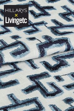 a blue and white fabric with an abstract design on it's back side, featuring the