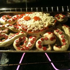 the pizzas are being cooked in the oven with pepperoni and cheese on them