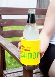 a woman sitting on a bench holding a bottle of soda