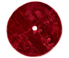 a red round rug with two holes in the middle