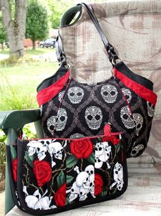 two skulls and roses purses sitting on a chair