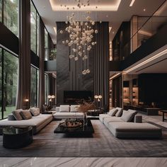 a large living room with couches, tables and chandelier hanging from the ceiling