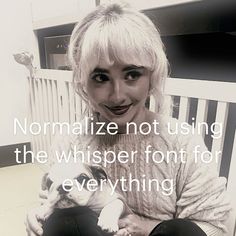 a woman sitting on a bench holding a small dog in her lap with the caption normalize not using the whisper font for everything