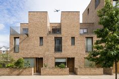 an apartment building with brick walls and balconies