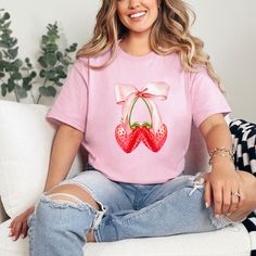 "Trendy Coquette Strawberry Bow T shirt Strawberry Bow top gift for her girly spring shirt Ribbon Cherry Pink unisex t-shirt cottagecore 90s PLEASE READ FULL LISTING 🌟 Listing is for 1 shirt 💕Several color options to choose from: Light Pink, Baby Blue, Sand or Heliconia 🏵️Sizes ranging from xs through 2XL. ❤️ if you dont see your size just give me a shout 😝 CARE INSTRUCTIONS ❌* DO NOT iron directly on Heat Transfer Graphic. Iron on low heat with shirt inside-out ❌ Never iron directly over design ✅* Machine wash COLD with mild detergent ❌* DO NOT dry clean ✅* Turn inside out when washing ✅* Dry on low setting or hang to dry ❌* Do not use bleach Gildan G500 Style 5.3 oz., 100% preshrunk cotton Double-needle sleeve and bottom hems Taped neck and shoulders Classic midweight fabric Classic Bow Clothing, Coquette Strawberry, Grandmothers Love, Bow Top, Spring Shirts, Pink Baby, Top Gifts, Design Design, Heat Transfer