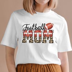 a woman wearing a football mom t - shirt