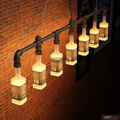 a group of lights hanging from the side of a brick wall