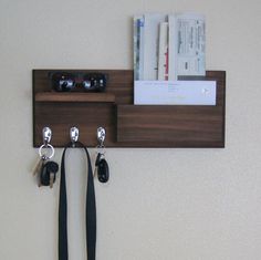 a couple of keys are hanging on a wall with some hooks attached to the hooks