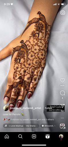 a woman's hand with henna tattoos on it