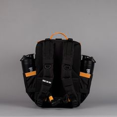 the back view of a black backpack with orange straps and two bottles attached to it