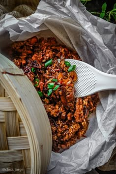 the food in the basket is ready to be eaten by the person with the plastic spatula