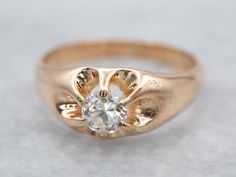 a gold ring with a diamond in the center