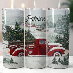 three red trucks with christmas trees on them are sitting in front of a white table