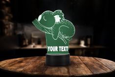 a table with a lit up sign that says your text on it and a chicken in the middle