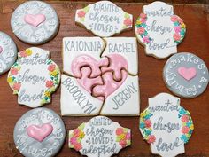 decorated cookies with names and hearts on them are arranged on a wooden table in the shape of heart