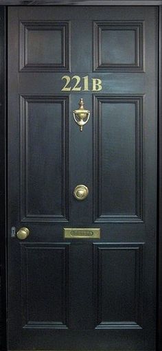 a black door with the number twenty two in gold on it's front and side