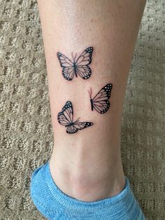 three butterflies on the ankle tattoo design for women and girls, one is black with white dots