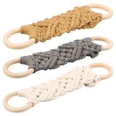 three wooden rings with rope handles on each one and two different colored ropes attached to them