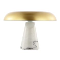 a white and gold table lamp against a white background