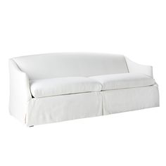 a white couch sitting on top of a white floor