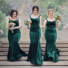 three bridesmaids in green dresses are walking down the stairs with their bouquets