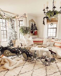 a living room filled with lots of furniture and christmas trees in the corner window sill