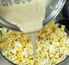 a blender filled with popcorn being poured into it