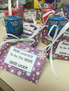 some candy bars are tied up on a table with tags that say, rush yourself to be the best good luck