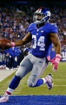 a football player running with the ball in his hand