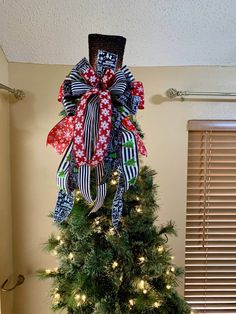 a decorated christmas tree in the corner of a room