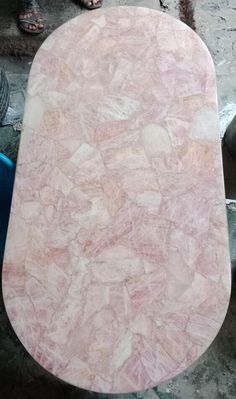 a large pink marble slab sitting on top of a sidewalk