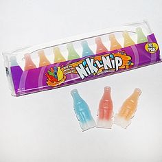 an assortment of different flavored gummy bears in a tube with the package open