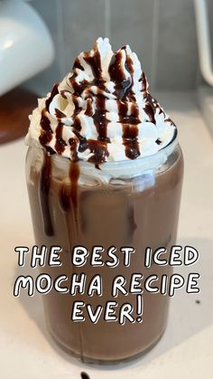 the best iced mocha recipe ever is in a glass with whipped cream and chocolate drizzle