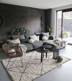 a living room filled with furniture and a large window covered in plants on top of a white rug