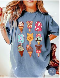 a woman wearing a blue tee shirt with ice cream and teddy bears on the front