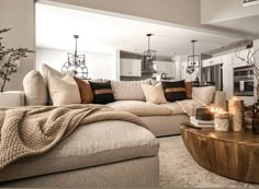 a living room filled with furniture and candles