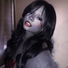 a woman with long black hair and red lipstick